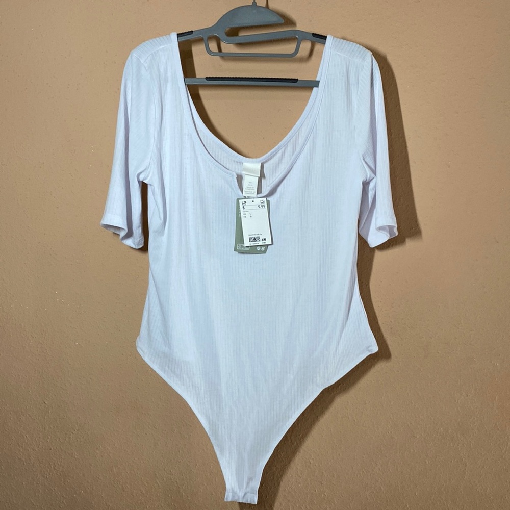 White quarter sleeve large body suit.